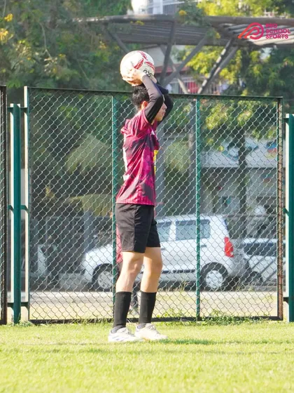 A player prepares for a throw-in, a crucial part of maintaining possession and restarting play.