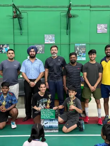 A group of our summer camp winners posing with their trophies and the coaching team.