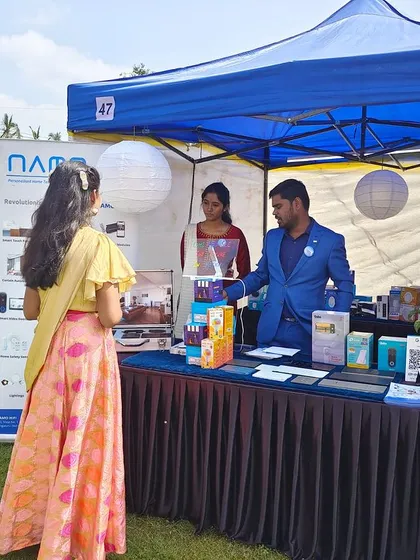 We believe in connecting with our community and demonstrating our technology firsthand. This image shows our team engaging with a visitor at our stall during an event, explaining the practical benefits of our smart automation and audio-visual solutions.