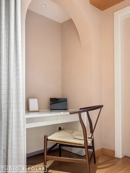 Another arched niche is transformed into a compact and elegant study area. This thoughtful use of space ensures the room is not only beautiful but also highly practical for modern life.