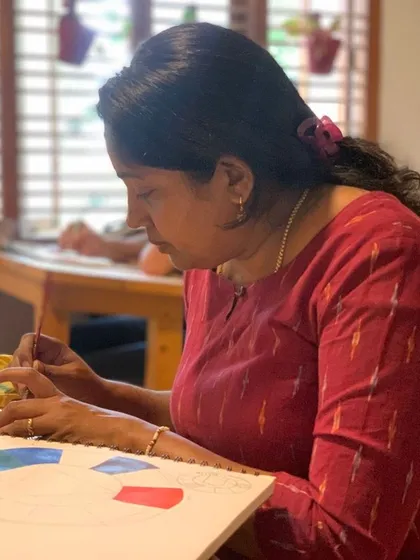 A student practices color theory by painting a color wheel. This foundational exercise is a critical step for any painter, and our classroom provides the perfect setting for it.