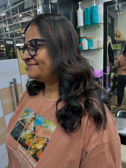 Soft highlights woven through a medium-length cut. This is a great way to add a little brightness and interest to your hair without a drastic change.