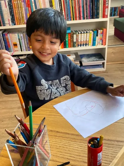 A young Star Wars fan shows off his masterpiece at the art table. We love seeing kids' passions come to life.