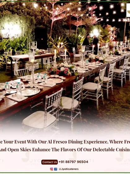 An al fresco dining experience under the stars. This long table setup, illuminated by string lights and candles, creates a magical and intimate atmosphere for an outdoor event.