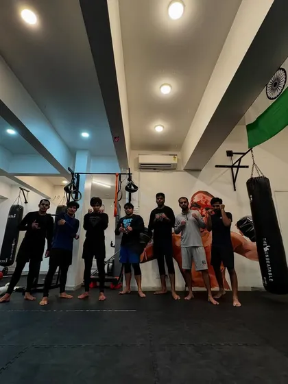 The team posing after a training session, a mix of beginners and experienced fighters.