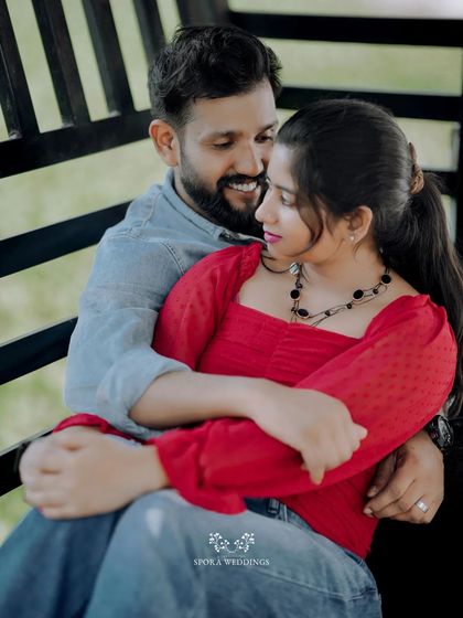 The couple sharing an intimate moment on a bench, their embrace full of warmth and affection.