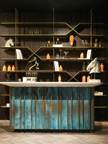 A centerpiece of our exhibit at the AD Design Show, this iconic bar unit makes a bold statement. The base is crafted from oxidized metal, creating a unique patina, while the sleek, distressed metal shelving system provides a perfect, contrasting backdrop.