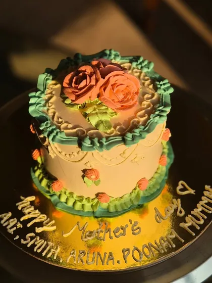 A sunny shot of the vintage Mother's Day cake, with the names of all the mums written in gold.
