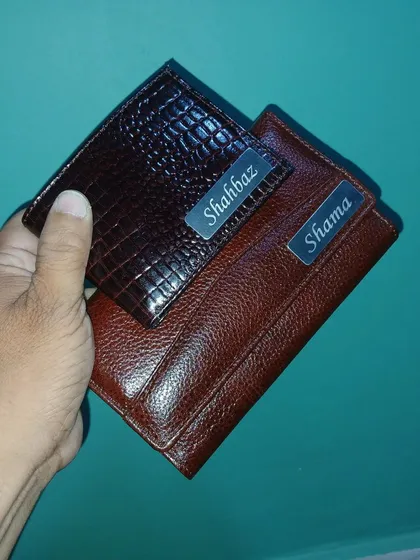 I also create matching sets for couples. Here is a men's wallet in crocodile texture and a women's clutch in plain leather, both with engraved nameplates.