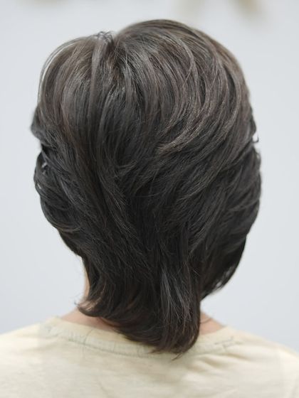 The back of the boy's haircut is expertly layered for a natural, tidy look.