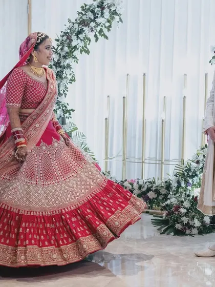 The bride gives a playful twirl for her groom. This shot is full of life, showcasing her stunning lehenga and joyful spirit.