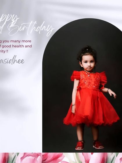 A beautiful portrait for a second birthday. The striking red dress against a dark background creates a timeless and elegant look.