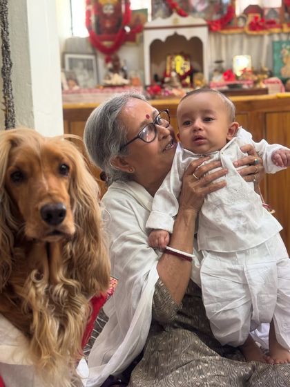 Dida (grandmother) with both her grandsons, human and furry, during the Poila Boishakh celebrations.