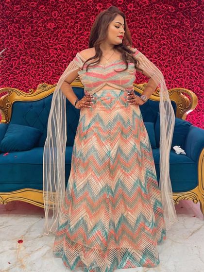 This client is rocking a trendy chevron-patterned lehenga for a sagan ceremony. The unique design and cape-style sleeves make it a modern and fashionable choice for any wedding function.