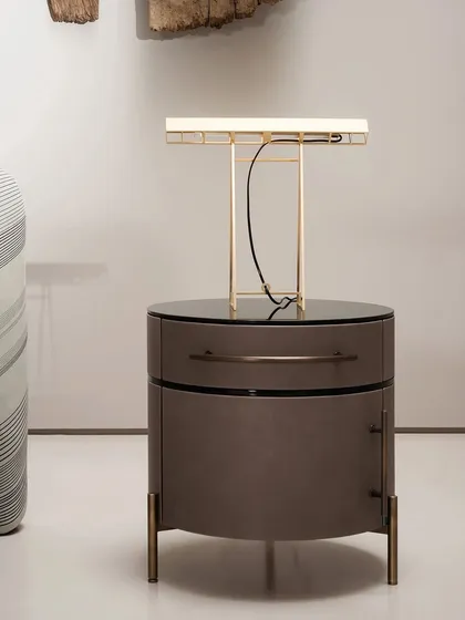 Our PLUSE night table shown in a rich brown leather. The top is black-lacquered glass, providing a sleek and durable surface, perfect for a modern luxury bedroom.