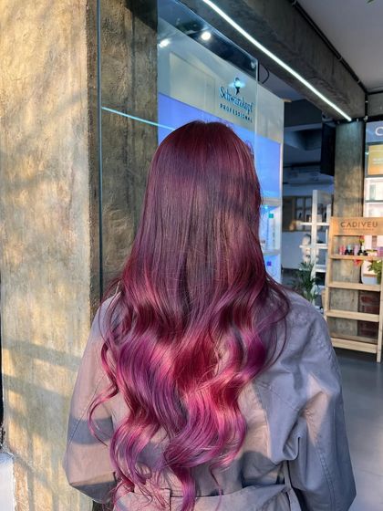 A still shot of the red-violet ombre, capturing the beautiful gradient and the healthy shine of the hair.