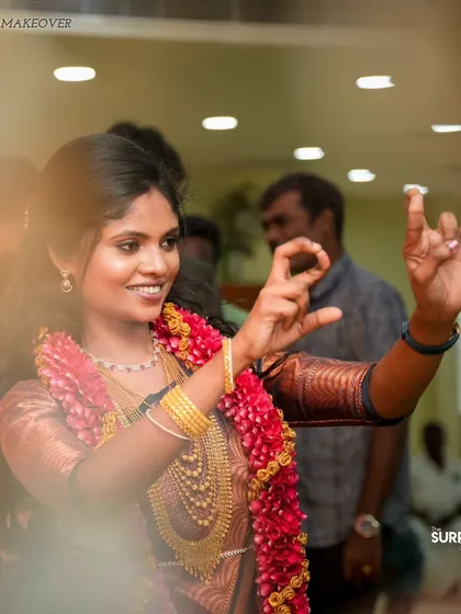 A candid moment from a reception. The bride is dancing and enjoying her special day, with her makeup looking just as fresh as when it was first applied.