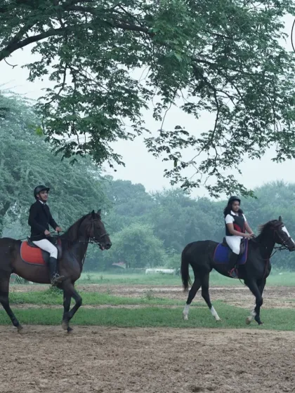 A serene moment as two riders enjoy a quiet ride together amidst the greenery of our club.
