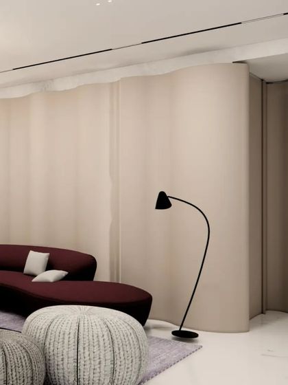 This render shows the interplay of curves and color in the Gulecha Residence. A deep red curved sofa is set against a gently undulating wall, with a modern, free-form chandelier above. The design creates a space that feels both dynamic and enveloping.