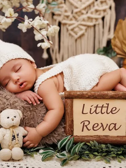 Little Reva sleeping peacefully in a rustic setup, personalized with her name. These details make each session unique.