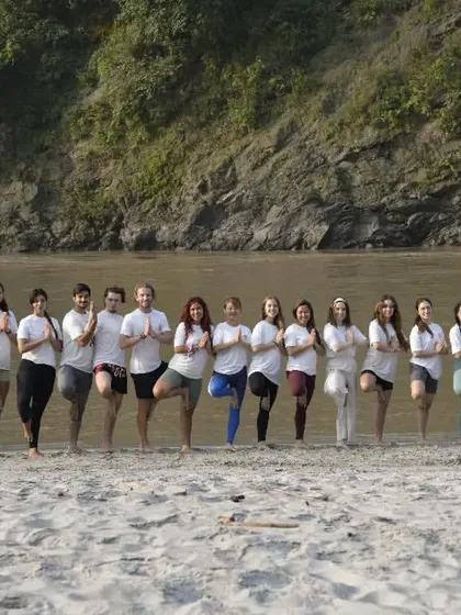 A shot of our yoga group practicing Vrikshasana (Tree Pose) together by the river in Rishikesh. I often organize these sessions to help us connect with nature and build a strong community, or 'bhaichara', through yoga.