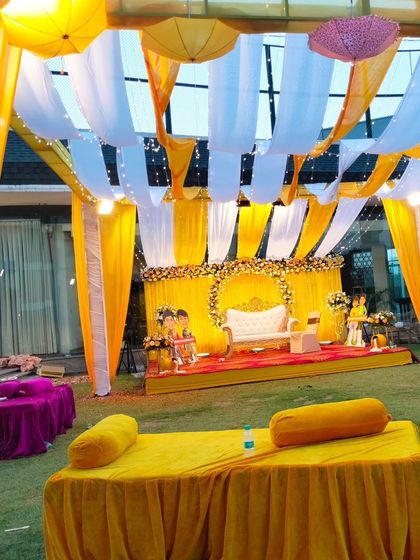 Another view of the outdoor Haldi setup, showing the combination of stage seating and relaxed floor seating for guests.
