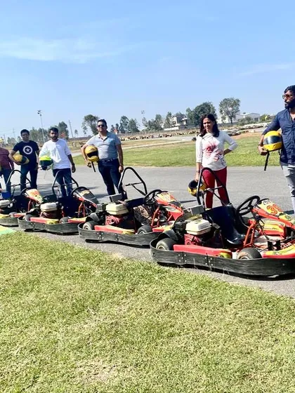 A group of friends posing with their karts after a fun session. Arrive with your friends and leave with great memories and a new level of confidence.