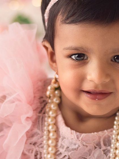 A close-up of our little princess. Her beautiful eyes and the delicate details of her pearl necklace made this shot so special during her first birthday session.