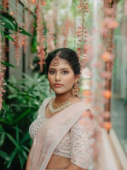 Another beautiful, candid shot of the groom's sister. The makeup is soft and natural, allowing her own beauty and the lovely surroundings to take center stage.