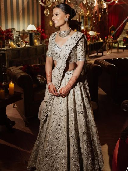 For her sangeet, this bride wore a chic, muted-tone lehenga. You'll learn to create an elegant, understated makeup look with a clean bun for a sophisticated evening event.