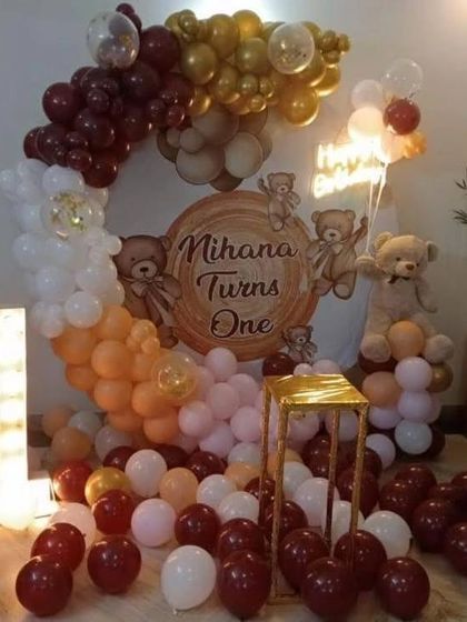 A cute teddy bear themed first birthday, "Mihana Turns One," with a custom backdrop and a balloon arch in brown, beige, and white tones.