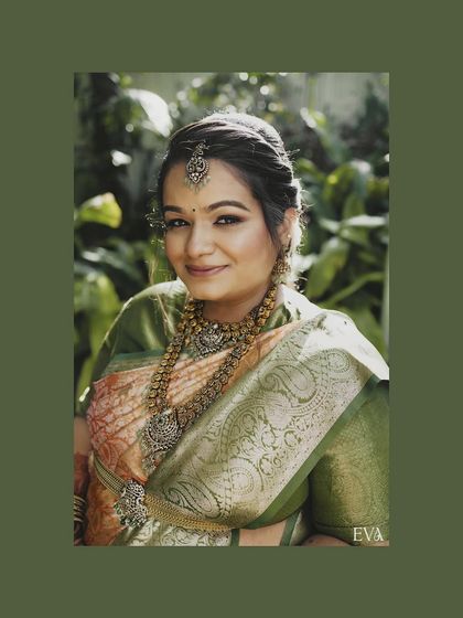 A close-up headshot of a radiant mother-to-be, adorned in traditional jewelry and a beautiful saree. Her gentle smile captures the inner joy and tranquility of this special time.