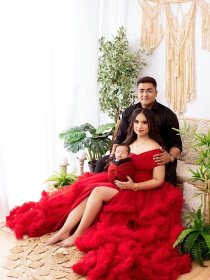 A full-length portrait showing the family in my boho studio setup. The red ruffled gown creates a stunning visual against the neutral background.