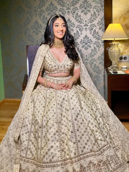 A full-length shot of Pooja's stunning bridal ensemble. Her makeup is perfectly balanced to complement the intricate details of her Anita Dongre lehenga.