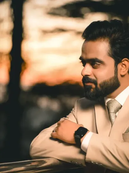 The groom looking out thoughtfully against a beautiful sunset backdrop. This is a powerful, moody portrait that feels both timeless and modern.