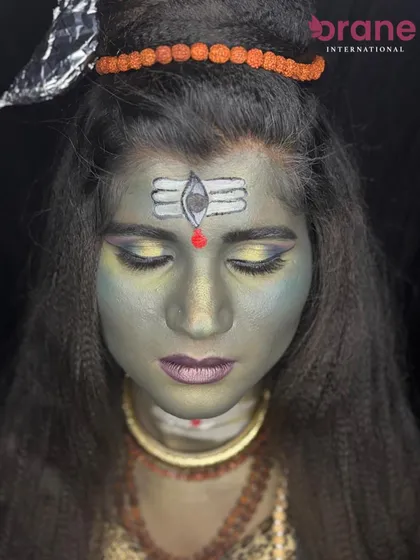 A close-up of the forehead, showing the detailed painting of the tripundra and third eye.