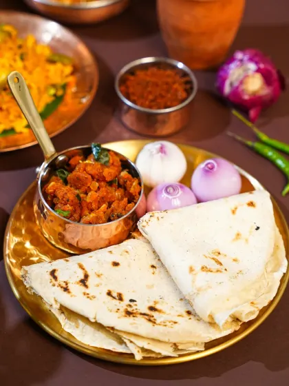 A simple, soulful Maharashtrian meal of thecha and bhakri. We styled this with whole onions and green chilies to represent the authentic, rustic way it's eaten in villages, celebrating the beauty of simplicity in food.