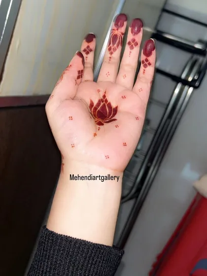 The final result is what matters most. This image showcases the beautiful, deep maroon stain of a minimalist lotus design after the henna paste has been removed. I provide detailed aftercare instructions to help you achieve this rich color.