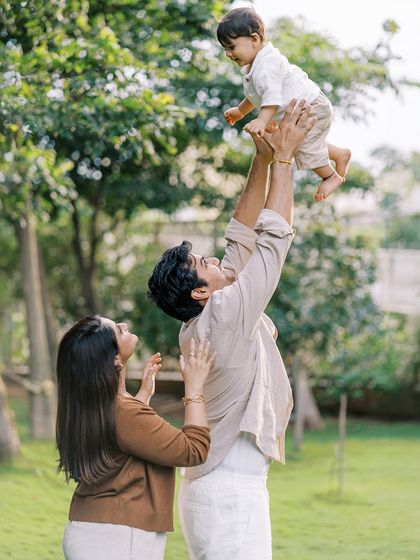 A father lifting his son high in the air. The joy and trust in this moment are what family photography is all about.