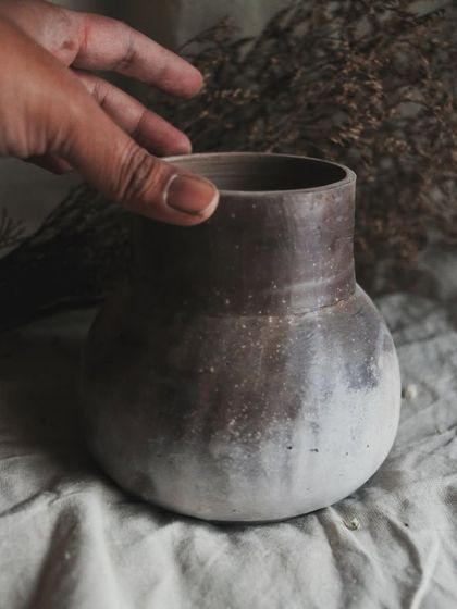 The simple, classic shape of this vase is the perfect canvas for the complex, organic patterns created by the pit fire. It feels wonderful to hold.