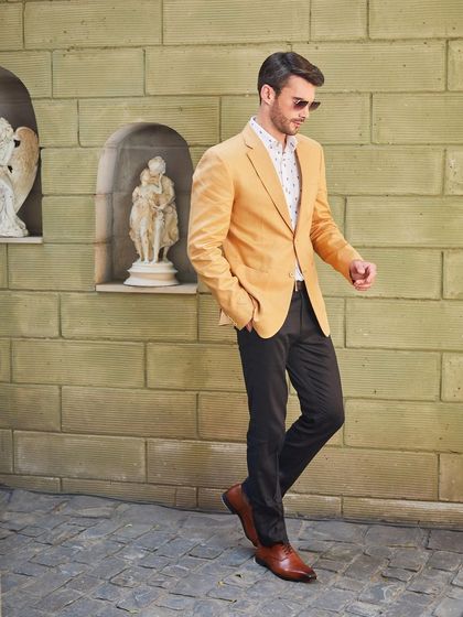 Let the honey-gold color of this Buttercup Yellow linen jacket brighten your summer wardrobe. I've paired it with dark trousers for a sharp contrast, creating a look that's perfect for a weekend getaway or a stylish brunch.