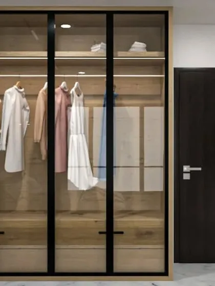 A concept for a modern walk-in wardrobe with glass doors and internal lighting.
