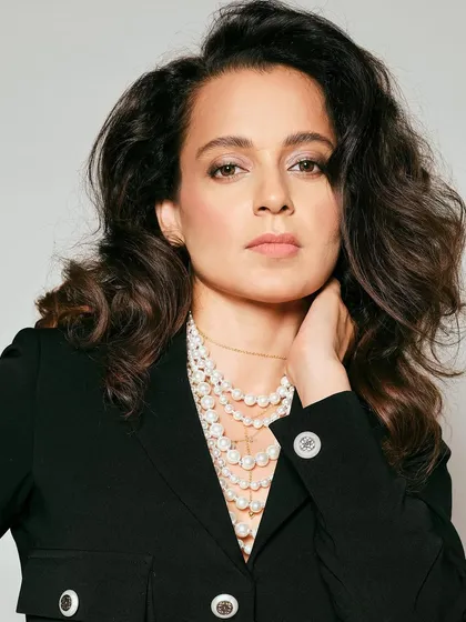 For Kangana Ranaut's trailer launch, we went for a chic and powerful look. This black cropped blazer and pencil skirt co-ord set from Ritu Neeva, layered with classic pearl necklaces, is all about sophisticated power dressing for press events.