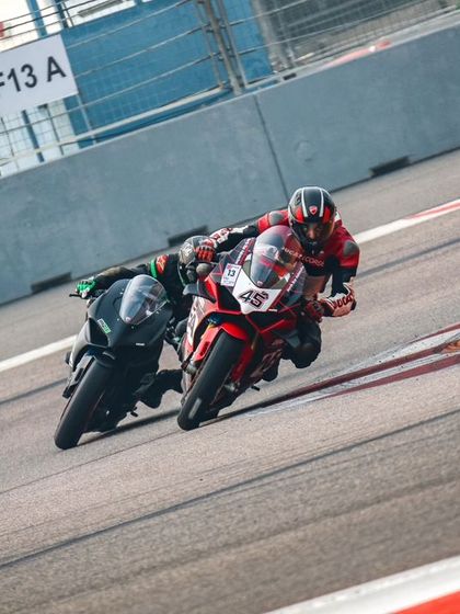 A close battle on the track, with one rider on a red superbike trying to hold the inside line against another. This is where racecraft and split second decisions make all the difference.