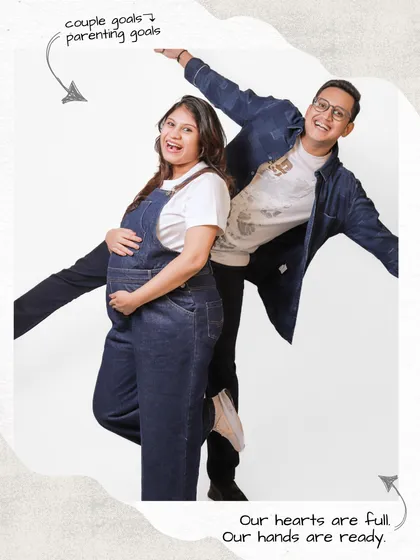 Maternity photos can be fun and playful too. This casual studio shot with denim dungarees shows the joyful and energetic side of expecting, celebrating the couple's unique personality.