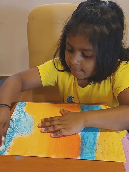 Using a cotton ball to smudge and blend pastels for a soft, dreamy effect in a seascape painting. We introduce various tools to achieve different artistic results.