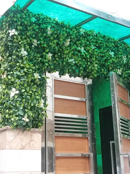 I love how this installation in Saket transformed the entrance of the house. The artificial green wall with white flowers wraps around the gate, creating a welcoming and lush first impression.