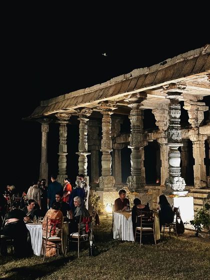 Another shot of the magical Hampi event, with guests dining under the stars next to the illuminated ruins.