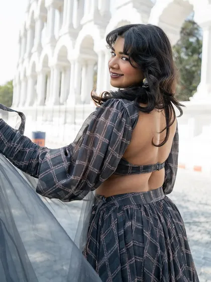 Another look at our fun and playful grey plaid lehenga. The open back and bishop sleeves make it a unique Indo-western piece.