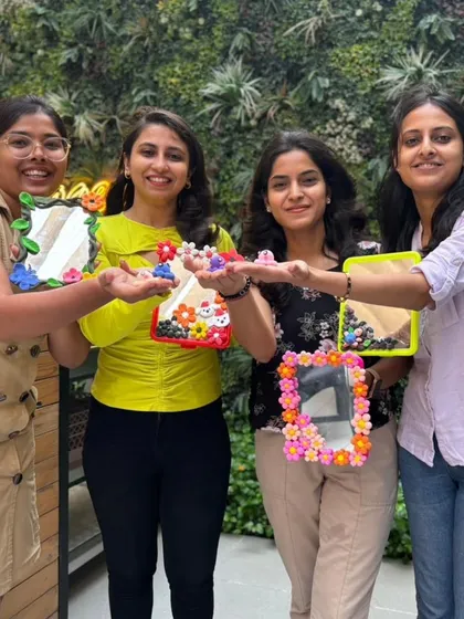 A group of friends showcasing the different styles of mirrors they designed, from Hello Kitty to abstract floral patterns.